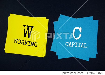 Working Capital (WC) text message on stick note on black background 129628366