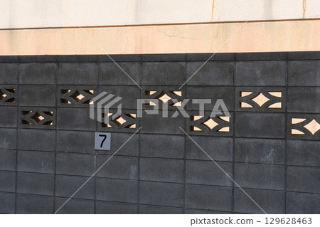 Block wall in the shade 129628463