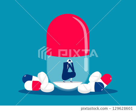 NO Drugs. Businesswoman sitting and sad inside big pil 129628601