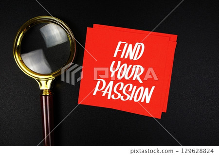 Find Your Passion text on sticky note with magnifying glass on black background Find Your Passion text on sticky note with magnifying glass on black background 129628824