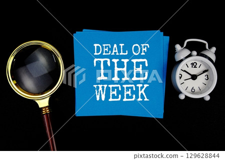 Deal Of The Week text on sticky note with magnifying glass and alarm clock on black background Deal Of The Week text on sticky note with magnifying glass and alarm clock on black background 129628844