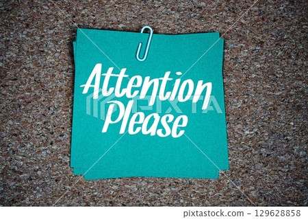 Attention Please text message on stick note on cork paper background 129628858