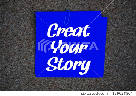 Create Your Story text message on stick note on cork paper background 129628864