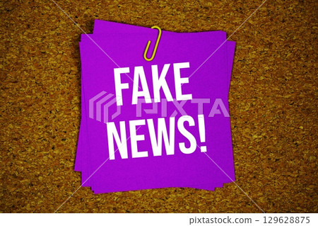 Fake News! text message on stick note on cork paper background Fake News! text message on stick note on cork paper background 129628875