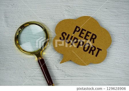 Peer Support text on speech bubble with magnifying glass on concrete background 129628906