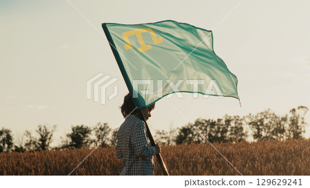 Crimean Tatar little Boy Holding National Flag in Wheat Field.Eastern European. 129629241
