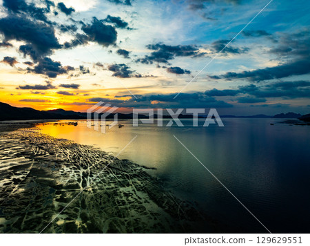 Aerial view sunset sky,Nature beautiful Light Sunset or sunrise over sea,Colorful dramatic majestic scenery sunset Sky with Amazing clouds and waves in sunset sky nature light cloud background 129629551