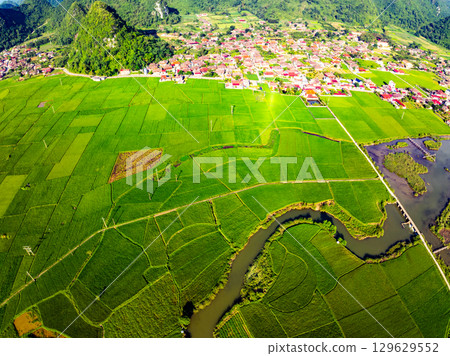 Aerial top view of Green rice field at northern vietnam,Beautiful destination in Northern Vietnam,Travel and landscape concept, Nature and rice fields background Aerial top view of Green rice field at northern vietnam,Beautiful destination in Northern Vietnam,Travel and landscape concept, Nature and rice fields background 129629552