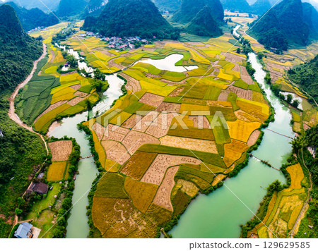 Aerial top view of Green rice field at northern vietnam,Beautiful destination in Northern Vietnam,Travel and landscape concept, Nature and rice fields background Aerial top view of Green rice field at northern vietnam,Beautiful destination in Northern Vietnam,Travel and landscape concept, Nature and rice fields background 129629585