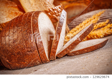 Fresh baked bread. Assorted bakery products loafs of bread and rolls... 129629674