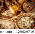 Vintage style travel and adventure. Vintage old compass and other vintage items on the table. 129629716