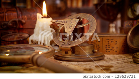 Vintage style travel and adventure. Vintage old compass and other vintage items on the table. Vintage style travel and adventure. Vintage old compass and other vintage items on the table. 129629721