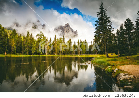 Magical forest surrounded by rocky peaks near the lake Antorno. Location place reserve Tre Cime di Lavaredo, Dolomite, Italy, South Tyrol, Europe. 129630243