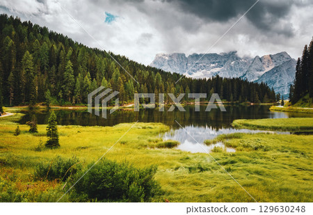 Popular high mountain lake Misurina in the Italian Alps. Location place Tre Cime di Lavaredo, Dolomite, South Tyrol, Italy, Europe. 129630248