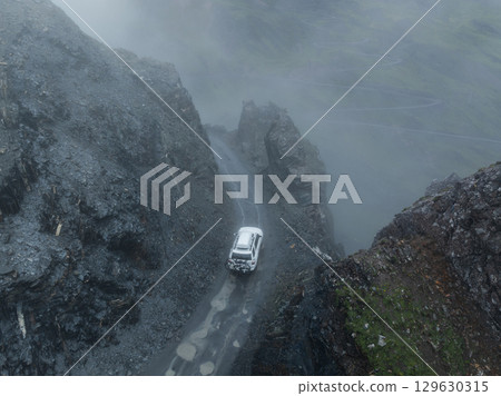 Driving off road car in high altitude mountains in tibet, China Driving off road car in high altitude mountains in tibet, China 129630315