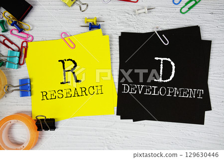 RD - Research and Development text on stick note with stationery on concrete background RD - Research and Development text on stick note with stationery on concrete background 129630446