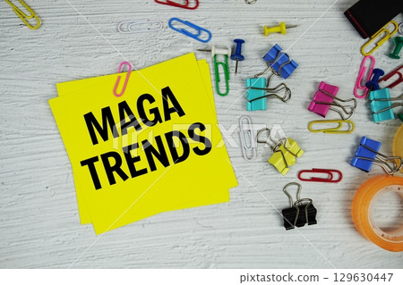 Maga Trends text on stick note with stationery on concrete background Maga Trends text on stick note with stationery on concrete background 129630447