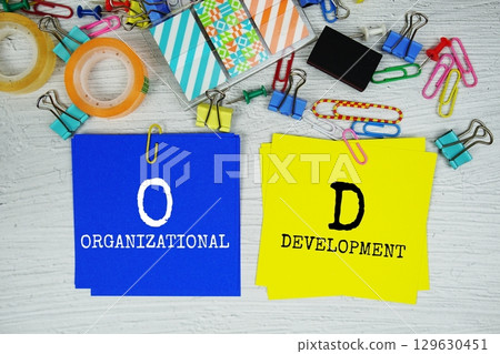 OD - Organizational Development text on stick note with stationery on concrete background OD - Organizational Development text on stick note with stationery on concrete background 129630451
