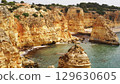 The coastal cliffs and stunning golden beach views create an unforgettable experience 129630605