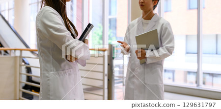 Men and women in white coats Men and women in white coats 129631797