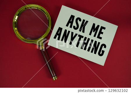 AMA Ask Me Anything text written on paper with magnifying glass 129632102