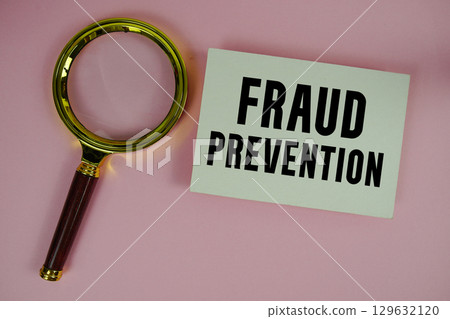Fraud Prevention text written on paper with magnifying glass Fraud Prevention text written on paper with magnifying glass 129632120