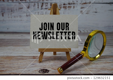 Join Our Newsletter text written on paper with magnifying glass 129632151