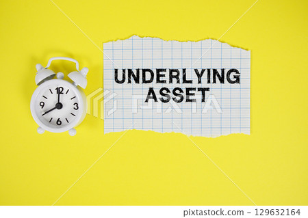 Underlying Asset text written on paper with alarm clock on yellow background Underlying Asset text written on paper with alarm clock on yellow background 129632164
