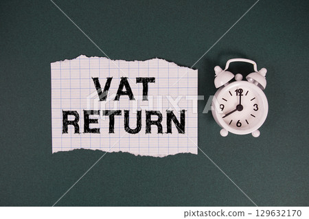 Vat Return text written on paper with alarm clock on green background Vat Return text written on paper with alarm clock on green background 129632170