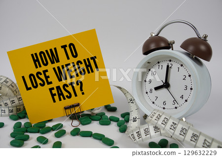 How To Lose Weight Fast? text with medicine, alarm clock and measuring tape on white background How To Lose Weight Fast? text with medicine, alarm clock and measuring tape on white background 129632229