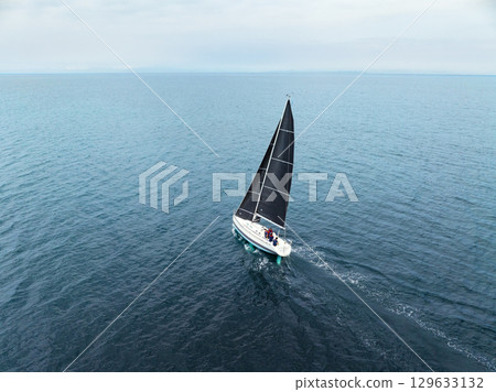 Drone aerial view of a yacht floating on the sea 129633132