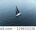 Drone aerial view of a yacht floating on the sea 129633136