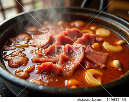 Close-Up Authentic Chinese Hot Pot with Sliced Meat and Vegetables 129633489