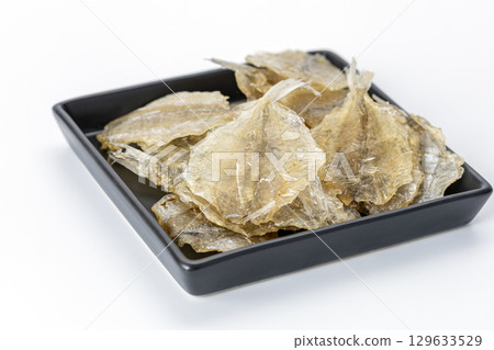 Dried sweet fish in a black plate. Scientific name is Parambassis siamensis. It is a type of food preservation. 129633529