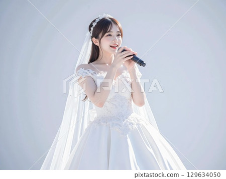 A woman wearing a wedding dress enjoying karaoke 129634050