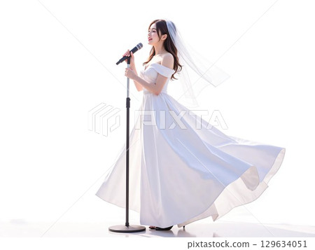 A woman wearing a wedding dress enjoying karaoke 129634051