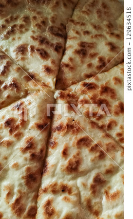 Delicious slices of khachapuri, traditional georgian cheese filled bread, baking in prague Delicious slices of khachapuri, traditional georgian cheese filled bread, baking in prague 129634518