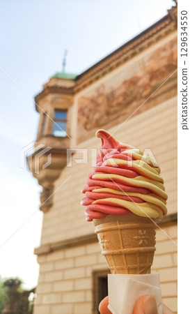 Tourist holding ice cream in front of building in prague pruhonice castle 129634550