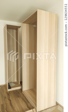 Assembling wooden wardrobe in modern apartment in prague 129634551