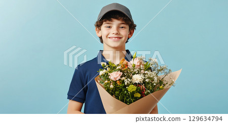 Young delivery boy holding bouquet of flowers for valentine's day 129634794