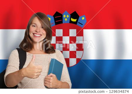 Cheerful woman student against Croatian flag background. Travel, education and learn language 129634874