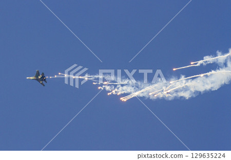 Sukhoi Su-30MK2 Fighter Of Vietnam People's Air Force Releases Flares On The Sky At The 50th Anniversary Of The Reunification Day. Sukhoi Su-30MK2 Fighter Of Vietnam People's Air Force Releases Flares On The Sky At The 50th Anniversary Of The Reunification Day. 129635224