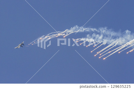 Sukhoi Su-30MK2 Fighter Of Vietnam People's Air Force Releases Flares On The Sky At The 50th Anniversary Of The Reunification Day. Sukhoi Su-30MK2 Fighter Of Vietnam People's Air Force Releases Flares On The Sky At The 50th Anniversary Of The Reunification Day. 129635225