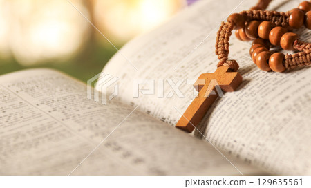 Wooden Jesus Cross on Old Book 129635561