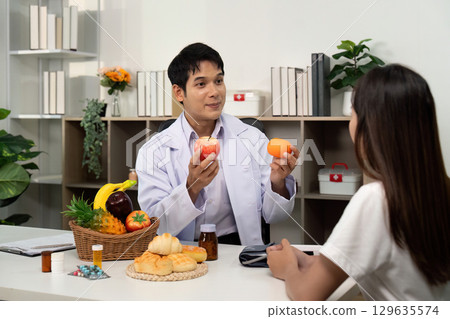 Nutrition Awareness. Doctor explaining fruit benefits to a patient in a consultation. 129635574