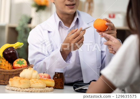 Nutrition Consultation. Health professional discussing healthy food choices with a patient. Nutrition Consultation. Health professional discussing healthy food choices with a patient. 129635575