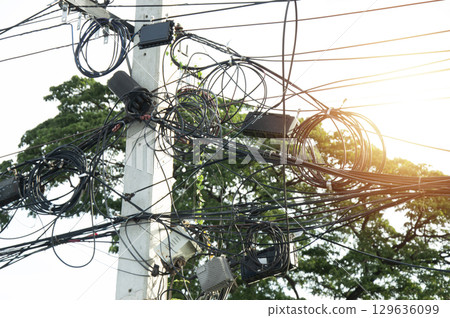 Image of tangled communication cables on poles Image of tangled communication cables on poles 129636099
