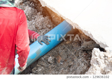 Workers are installing PVC pipes. 129636102
