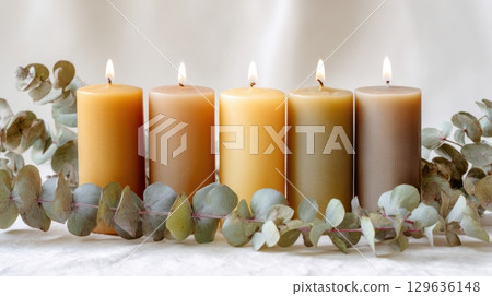 Stilllife with botanical decor and beeswax candles on matte white surface, minimal and calming composition for interior lifestyle content. Stilllife with botanical decor and beeswax candles on matte white surface, minimal and calming composition for interior lifestyle content. 129636148