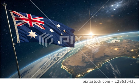 Australian flag waving in space above earth with sunrise in the background 129636433